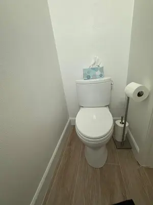a bathroom with a toilet with a box of tissues at Modern Laguna Beach Duplex - Prime Location! in Laguna Beach