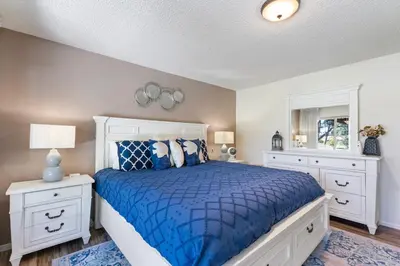 a bedroom with a blue bed and white cabinets at Home in San Diego! The Blue Leaf with 3bed 2bath, Golf, Large Yard! in Rancho Bernardo
