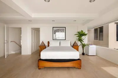 a bedroom with a bed and a plant in it at La Jolla Private Beach Oceanfront in San Diego