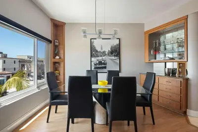 a dining room with a glass table and chairs at Pacific Beach Rooftop Views in San Diego