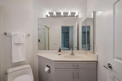 a bathroom with a sink and a toilet and a mirror at Pacific Beach Rooftop Views in San Diego