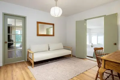 a living room with a couch and a table at Carlsbad Cottage - Remodeled in Carlsbad