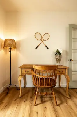 a wooden desk with a chair next to a lamp at Carlsbad Cottage - Remodeled in Carlsbad