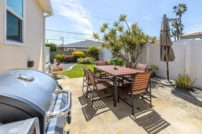 a backyard with a table and chairs and an umbrella at Carlsbad Cottage - Remodeled in Carlsbad