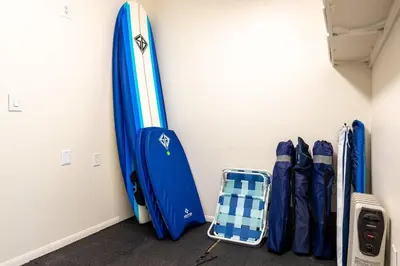 a room with a surfboard leaned against a wall at Carlsbad Cottage - Remodeled in Carlsbad