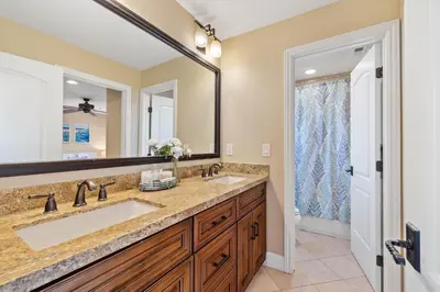 a bathroom with two sinks and a large mirror at Oceanview Luxe Retreat with Rooftop in San Diego