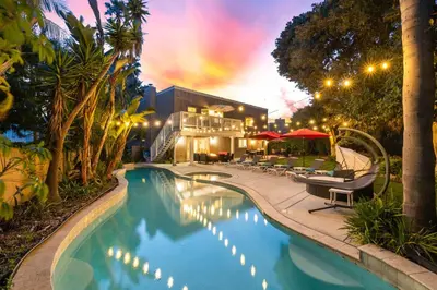 a swimming pool with lounge chairs and a building at Oceanview Luxe Retreat with Rooftop in San Diego