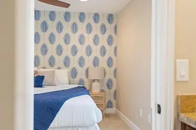 a bedroom with a bed and a blue and white wall at Oceanview Luxe Retreat with Rooftop in San Diego