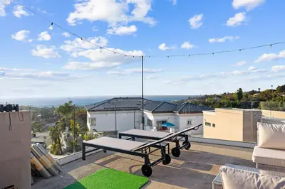a patio with a swing on the roof of a house at Oceanview Luxe Retreat with Rooftop in San Diego