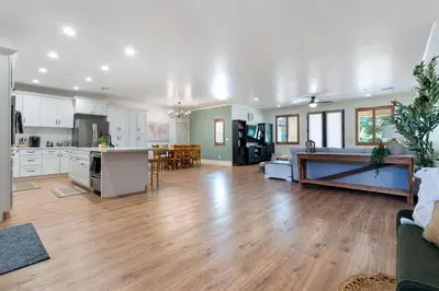 a large kitchen and living room with wooden floors at Luxury Escondido Family Oasis with Hot Tub in Escondido