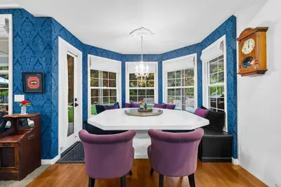 a dining room with a white table and purple chairs at Sprawling Escondido Estate Garden Pool Games ADU's in Escondido