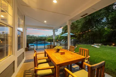 a porch with a wooden table and chairs on a house at Sprawling Escondido Estate Garden Pool Games ADU's in Escondido