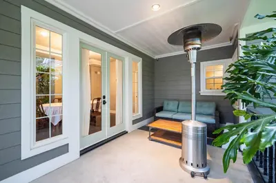 a porch with a blue couch and a window at Sprawling Escondido Estate Garden Pool Games ADU's in Escondido
