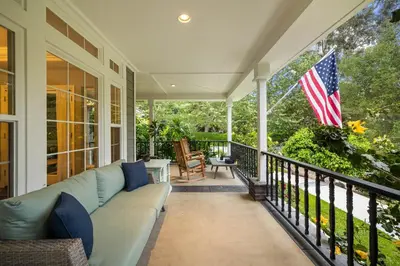 a porch with a couch and an american flag at Sprawling Escondido Estate Garden Pool Games ADU's in Escondido