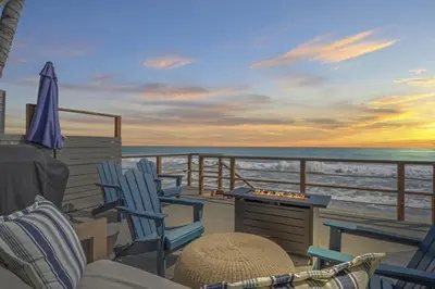 a deck of a boat with chairs and a table at Private beach toes on the Sand Waterworld in Dana Point