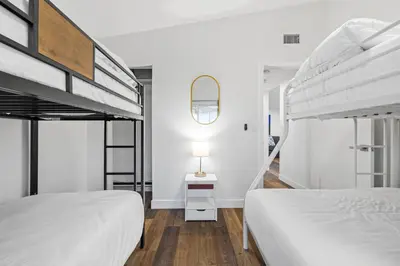 a bedroom with two bunk beds and a lamp at Dog-Friendly House with Hot Tub, AC, Game Room in Oceanside