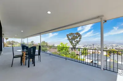 a view from the balcony of a house with a table and chairs at Sleeps 31 10br Mountain View, Pool, Spa and Games in El Cajon