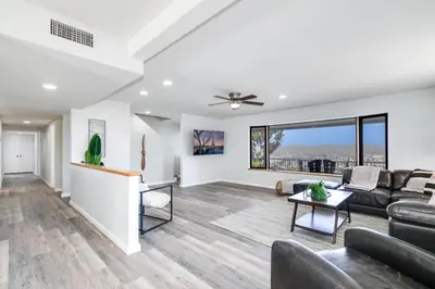 a living room with a couch and a table at Sleeps 31 10br Mountain View, Pool, Spa and Games in El Cajon