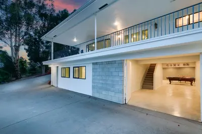 an exterior view of a house with a bench at Sleeps 31 10br Mountain View, Pool, Spa and Games in El Cajon