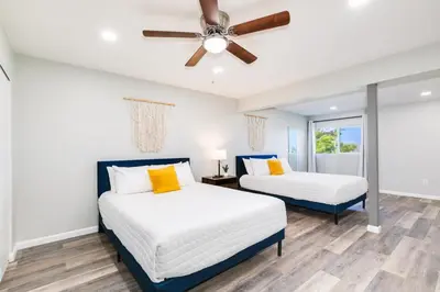 a bedroom with two beds and a ceiling fan at Mountain View 6BR Pool, Spa and Games Room in El Cajon