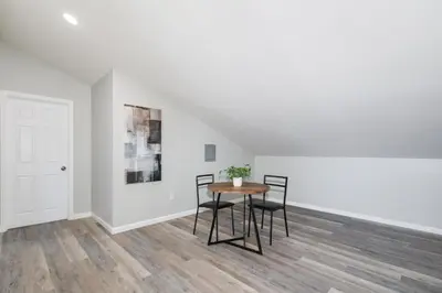 a room with a table and chairs and a white wall at Mountain View 6BR Pool, Spa and Games Room in El Cajon