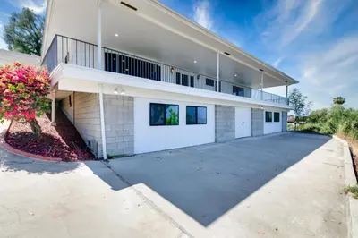 a large white house with a large driveway at Mountain View 6BR Pool, Spa and Games Room in El Cajon