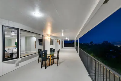 a balcony of a house with a table and chairs at Mountain View 6BR Pool, Spa and Games Room in El Cajon