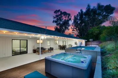 a house with a hot tub in the backyard at Mountain View 6BR Pool, Spa and Games Room in El Cajon