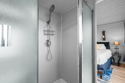 a shower in a bedroom with a bed at The SeaBarn Vista Views, Hot Tub and Stargazing in San Diego