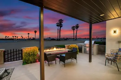 a patio with a fire pit and a sunset at Boardwalk Studio Shared Hot Tub and Patio in San Diego
