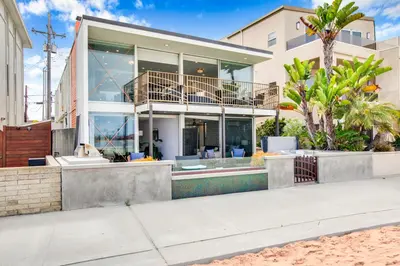 a house on the beach with palm trees at Boardwalk Studio Shared Hot Tub and Patio in San Diego