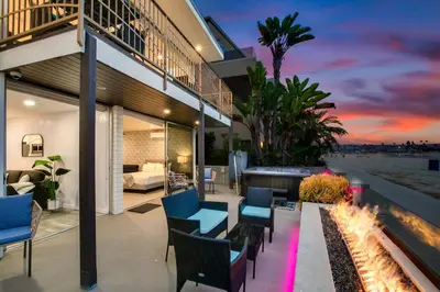 a patio of a house with chairs and a fireplace at Beachfront Bliss Cozy 1BR Condo with Shared Perks in San Diego