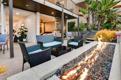 an outdoor patio with a fire pit and chairs at Beachfront Bliss Cozy 1BR Condo with Shared Perks in San Diego