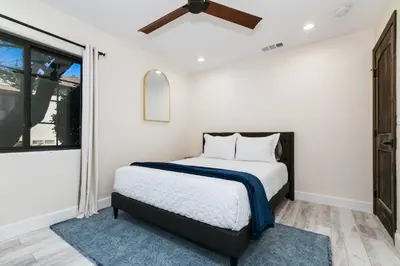 a bedroom with a bed and a ceiling fan at Luxury Oasis with Ping Pong, Firepit and Cozy Patio in San Clemente