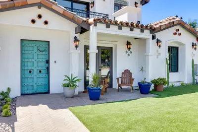 a house with a green door and a lawn at Luxury Oasis with Ping Pong, Firepit and Cozy Patio in San Clemente