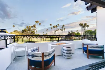 a patio with chairs and tables on a balcony at Inviting 3BR Space with Firepit in San Clemente
