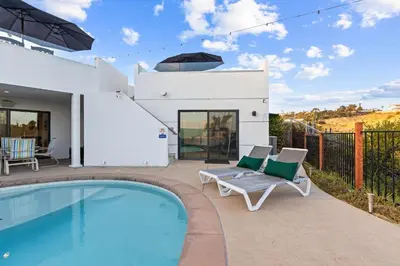 a villa with a swimming pool and a house at Modern La Jolla Escape Pool Rooftop Views in San Diego