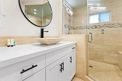a bathroom with a sink and a mirror at Modern La Jolla Escape Pool Rooftop Views in San Diego