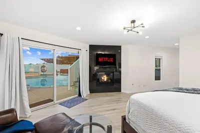 a bedroom with a bed and a fireplace at Modern La Jolla Escape Pool Rooftop Views in San Diego