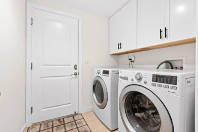 a white laundry room with a washer and dryer at Modern La Jolla Escape Pool Rooftop Views in San Diego