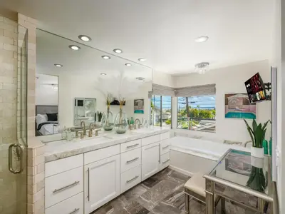 a bathroom with two sinks and a tub and a shower at Luxury Resort Pool, Spa, Swim Up Bar and Bay Views in San Diego