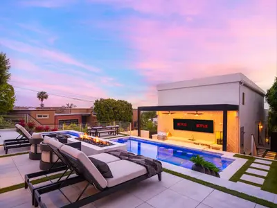 a backyard with a swimming pool and patio furniture at Luxury Resort Pool, Spa, Swim Up Bar and Bay Views in San Diego