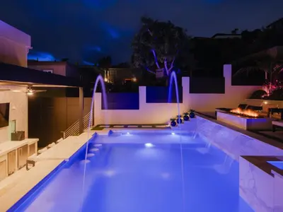 a swimming pool at night with blue lights at Luxury Resort Pool, Spa, Swim Up Bar and Bay Views in San Diego