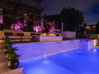 a swimming pool at night with purple lights at Luxury Resort Pool, Spa, Swim Up Bar and Bay Views in San Diego