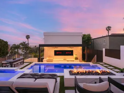 a backyard with a swimming pool and a fire pit at Luxury Resort Pool, Spa, Swim Up Bar and Bay Views in San Diego