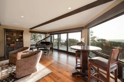 a living room with a table and a piano at Oceanfront Luxury Home Sunset Views in San Diego