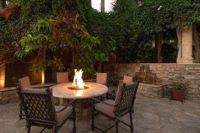a cat sitting on a table with a fire on it at Oceanfront Luxury Home Sunset Views in San Diego
