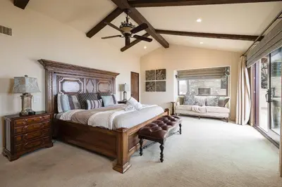 a bedroom with a large bed and a couch at Oceanfront Luxury Home Sunset Views in San Diego
