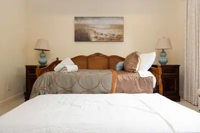 a bedroom with two beds and two lamps at Oceanfront Luxury Home Sunset Views in San Diego