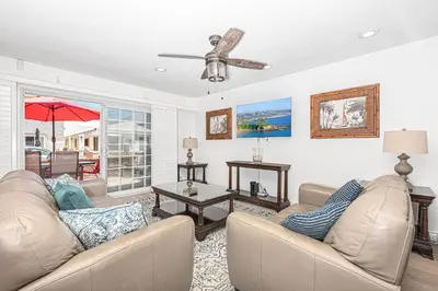 a living room with two couches and a ceiling fan at 3Br Coastal Home W Large Oceanview Patio, Steps To Sand By Beachview Rentals in Newport Beach